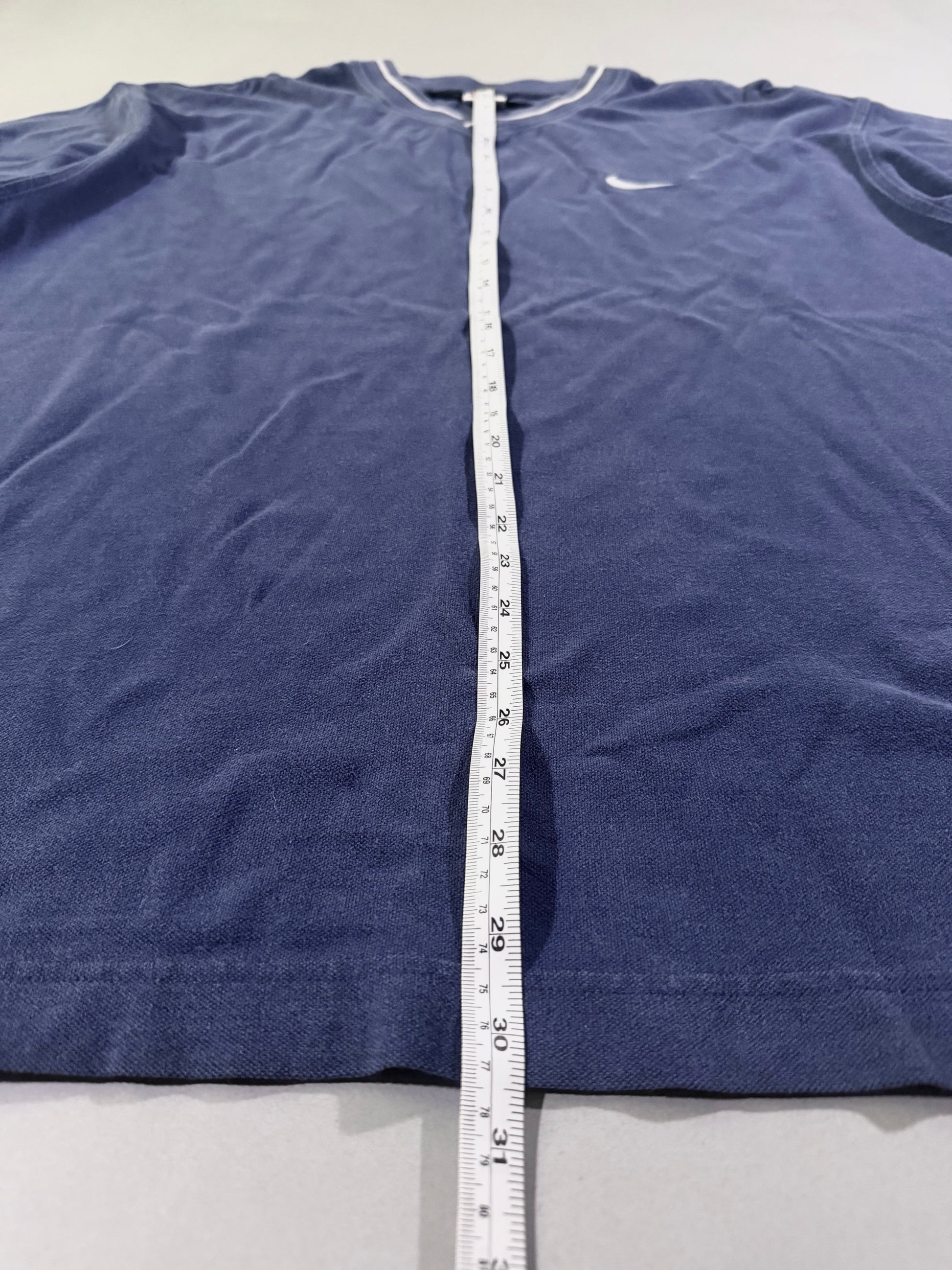 Length measurement of vintage Nike navy athletic V-neck T-shirt.