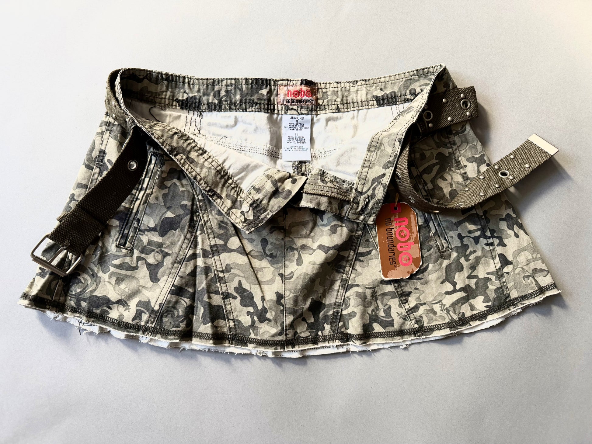 Photo of y2k camo mini skirt with original tags still attached and button fly open