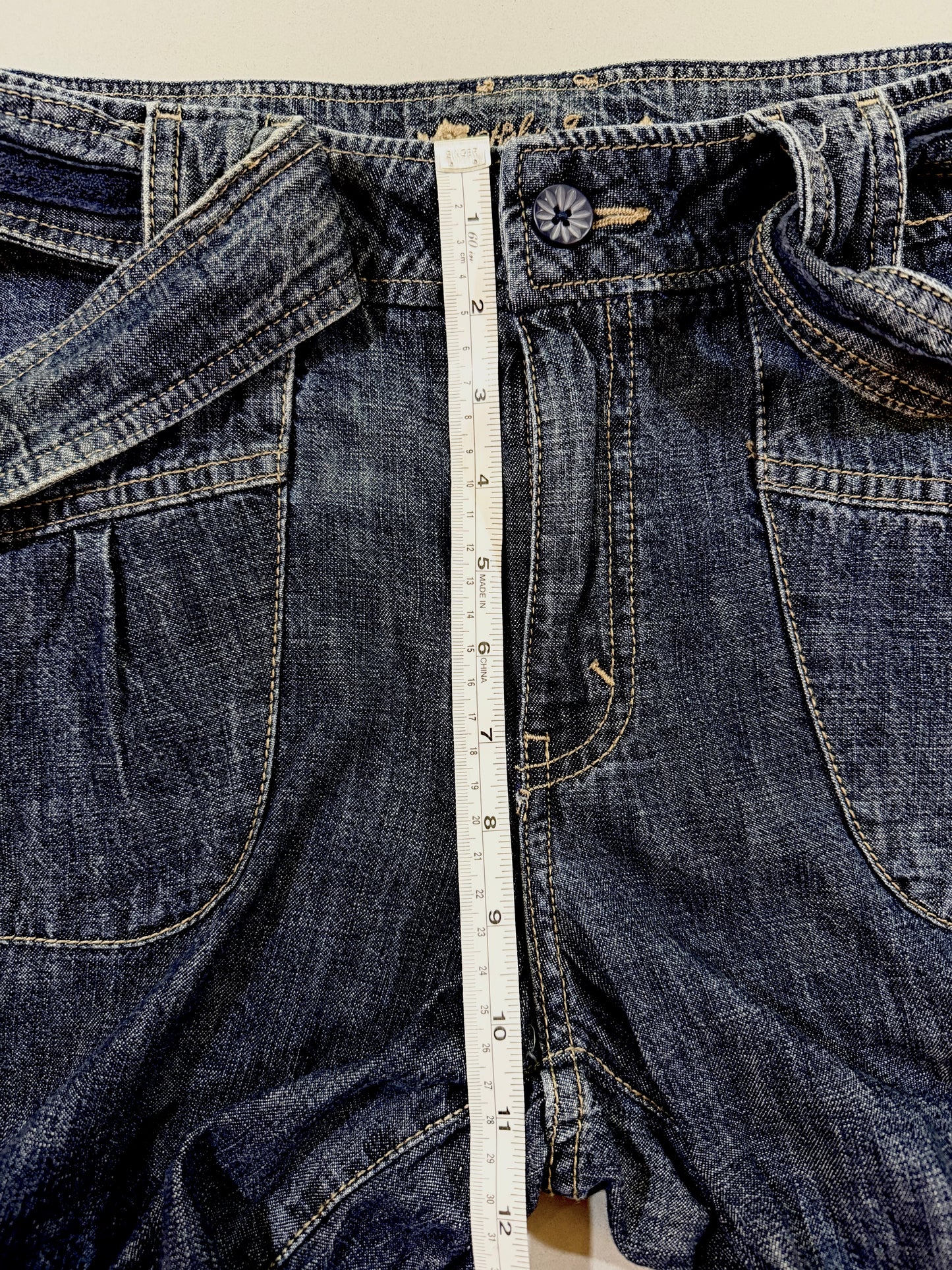 Front rise measurement shown on vintage denim cropped pants.