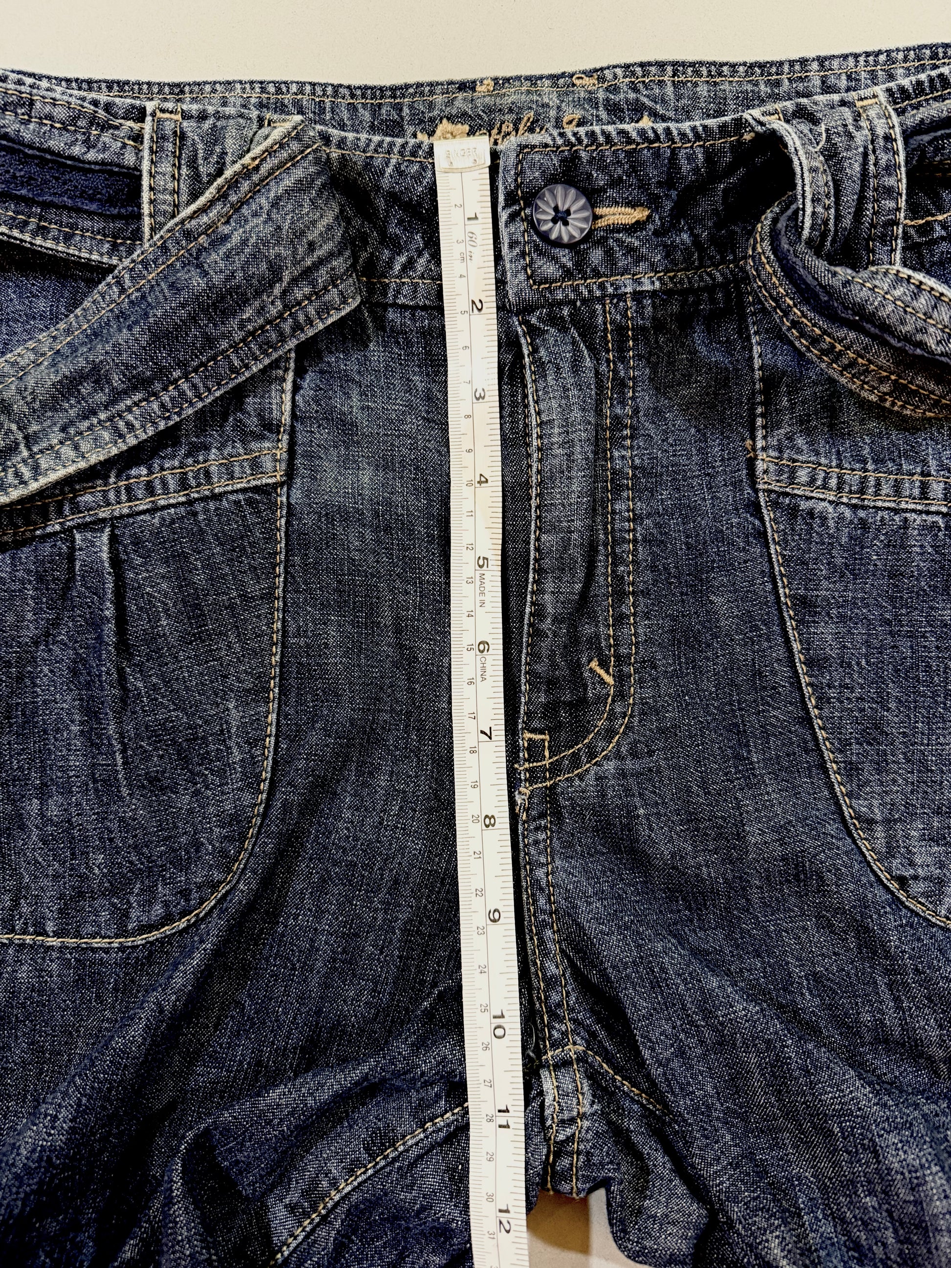 Front rise measurement shown on vintage denim cropped pants.