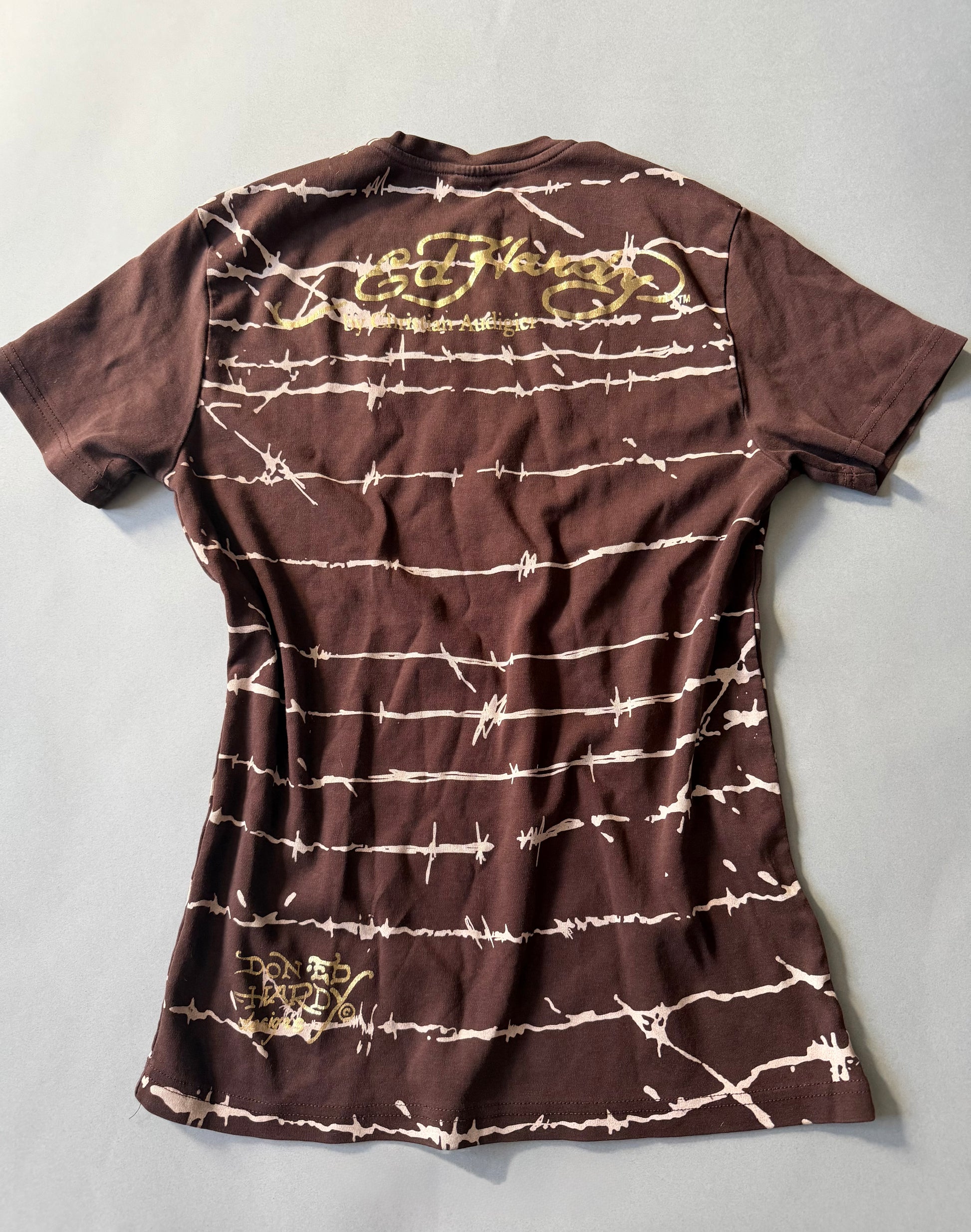 Photo of backside of brown Ed hardy t-shirt with all over barbed wire print. 