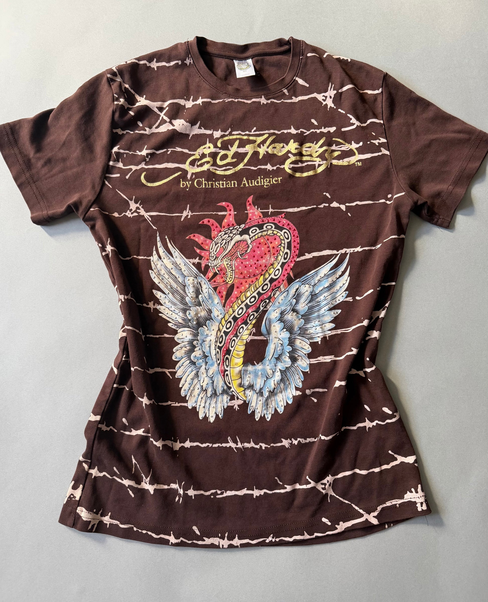 Photo of brown Ed hardy t-shirt with all over barbed wire print and winged snake graphic with rhinestones throughout. 