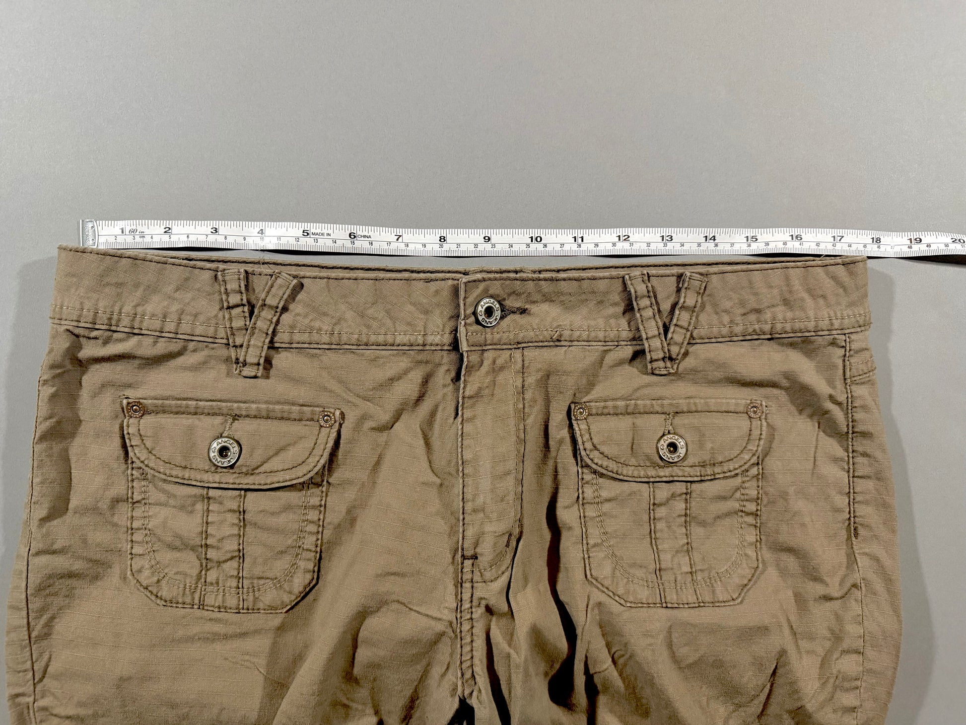 Waist measurement shown across the waistband of vintage Angels Jeans khaki ripstop capri pants.
