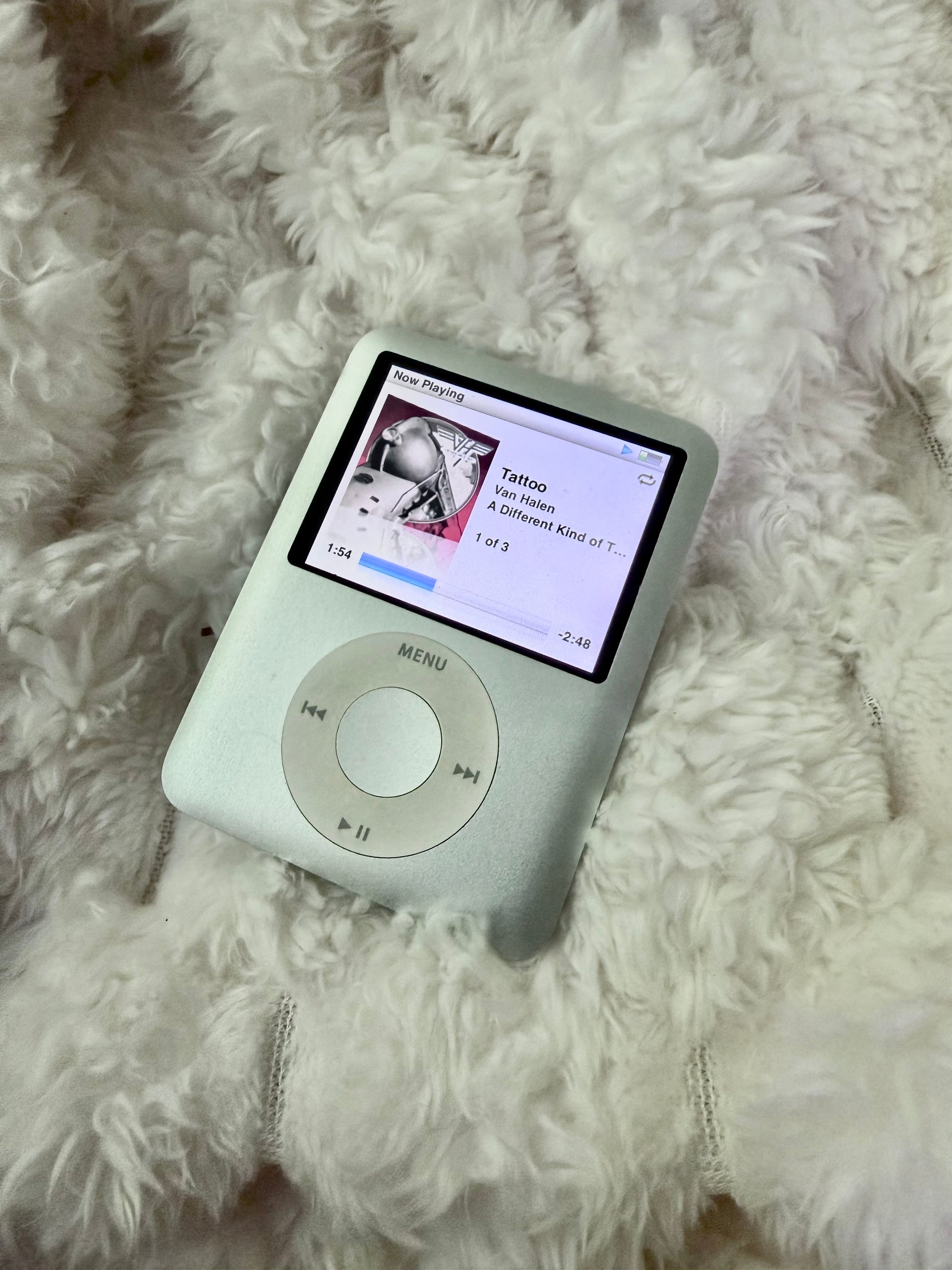 Silver Apple iPod nano 3rd generation displaying Van Halen “Tattoo” album artwork and Now Playing screen.