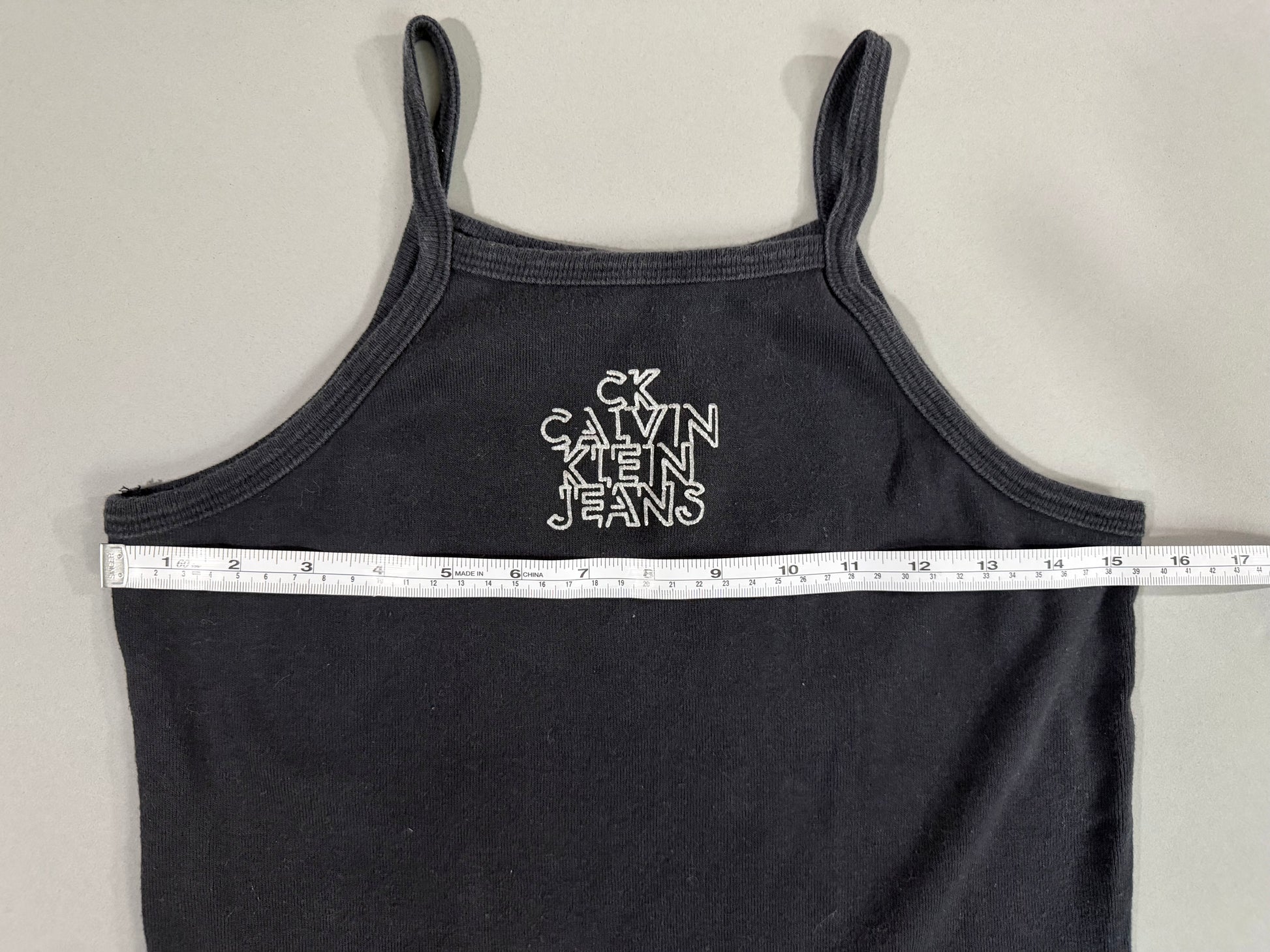 Pit-to-pit measurement of vintage Calvin Klein Jeans black mini dress.