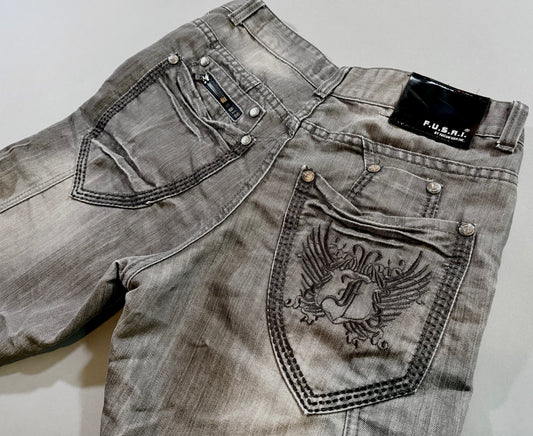 Close-up of embroidered back pocket, zipper detail, logo hardware, and black F.U.S.A.I. patch.