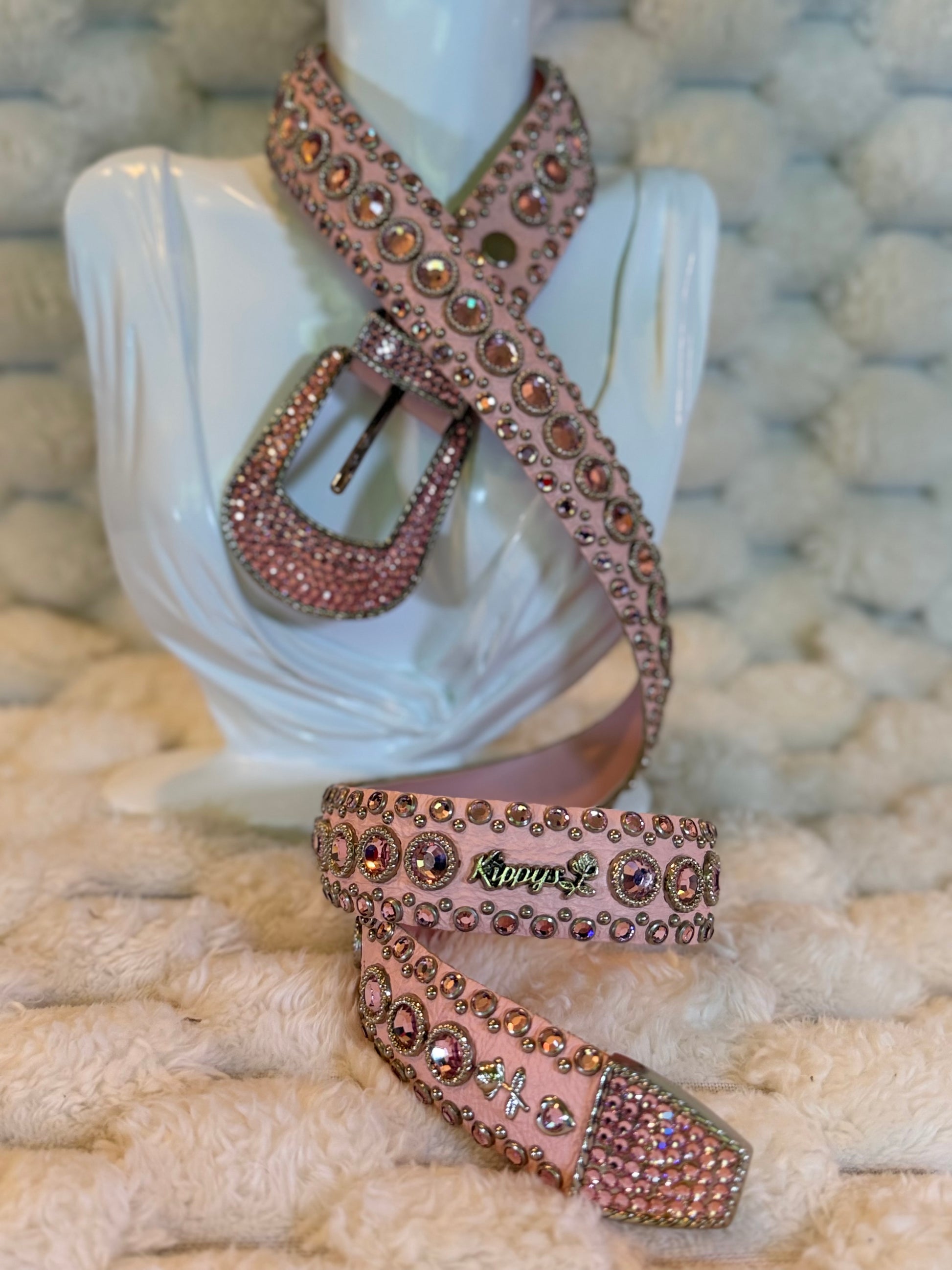 Vintage Kippy’s pink Swarovski crystal leather belt displayed on mannequin, showing jeweled Western buckle, studs and Kippy’s logo.