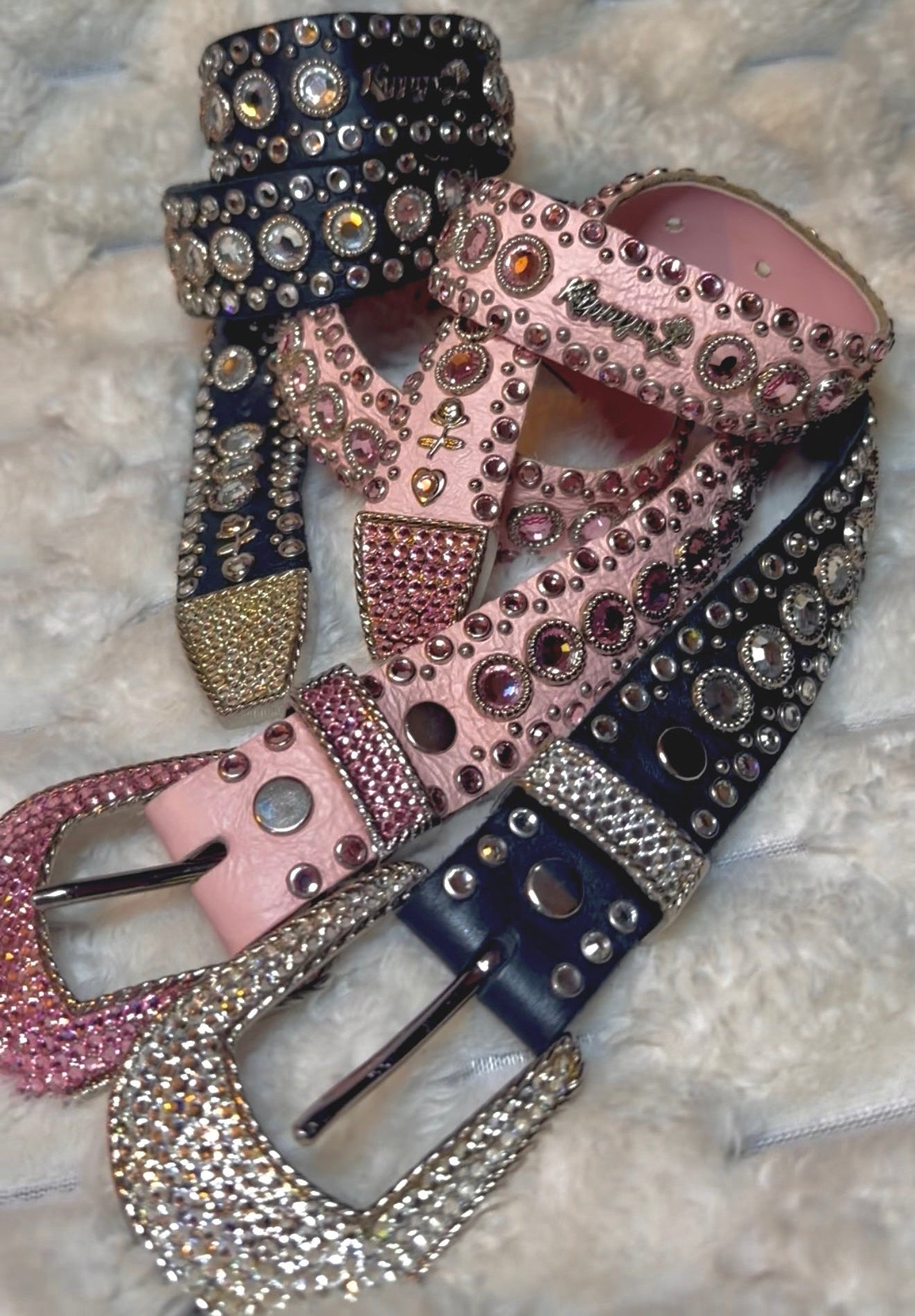 Vintage Kippy’s pink and black leather belts embellished with Swarovski crystals, silver studs and crystal-covered buckles.