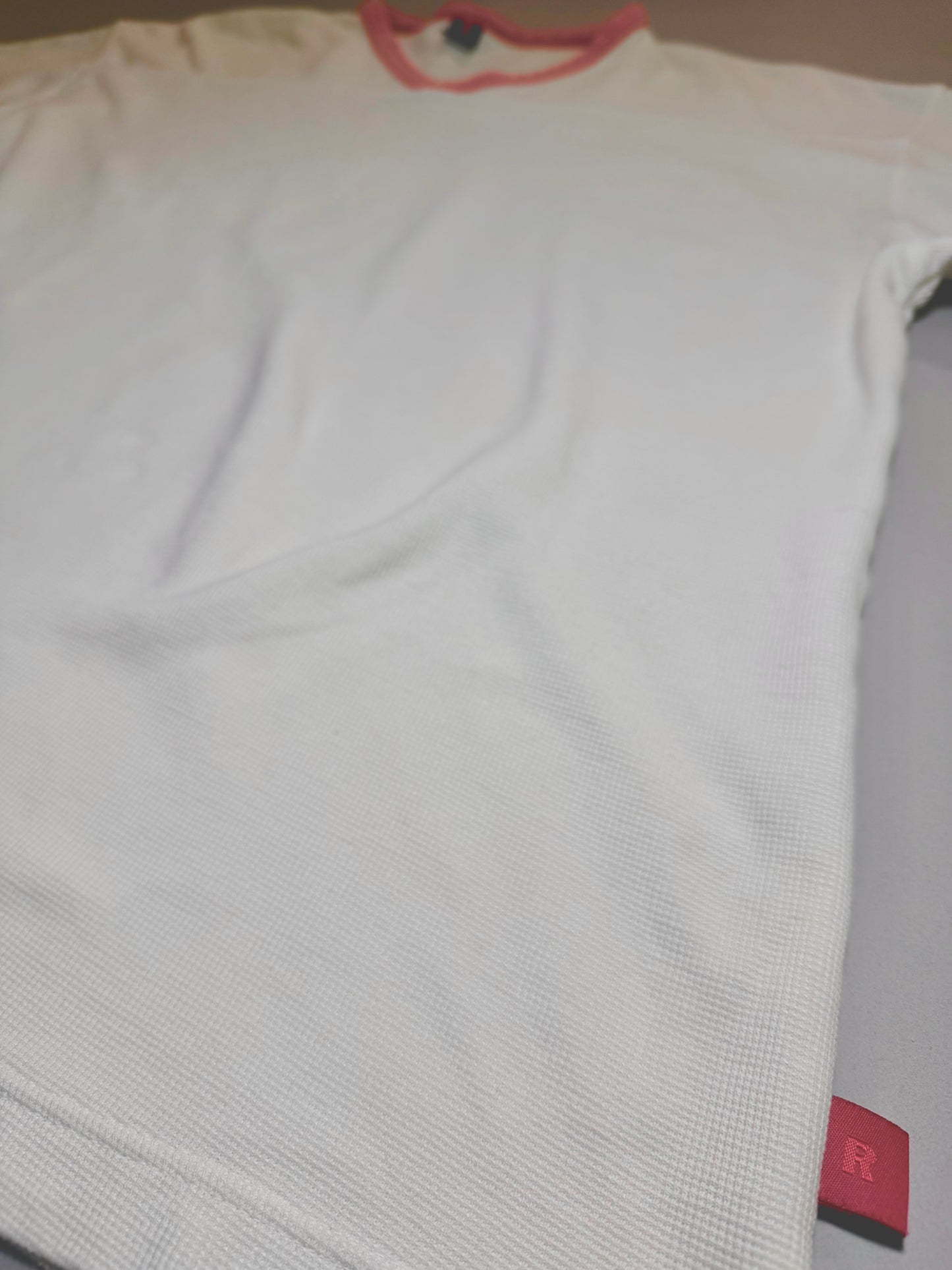 Close-up angled view of the textured waffle knit fabric and signature Levi’s Red Tab side seam label.