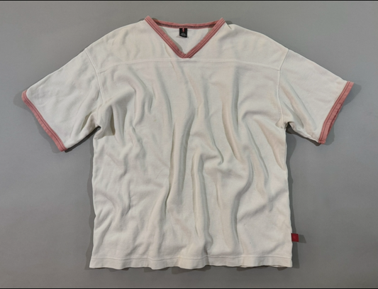 Vintage 1999 Levi’s Red Tab cream waffle knit short sleeve V-neck thermal shirt with salmon pink trim laid flat.