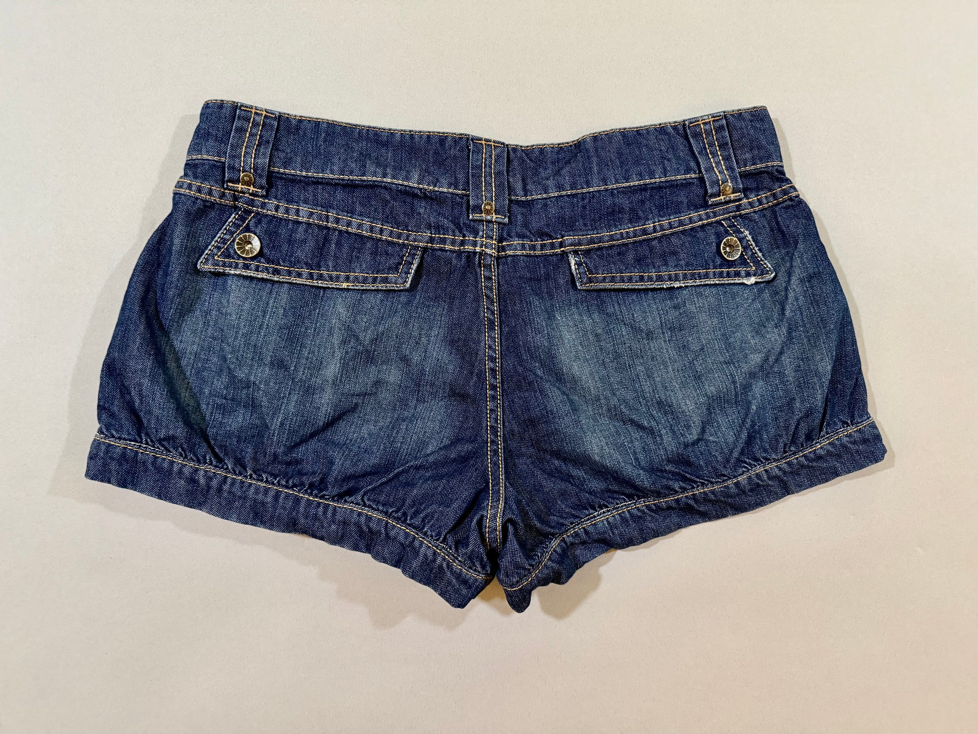 Back view of 2007 Nobo No Boundaries denim shorts with flap back pockets and cuffed hems.