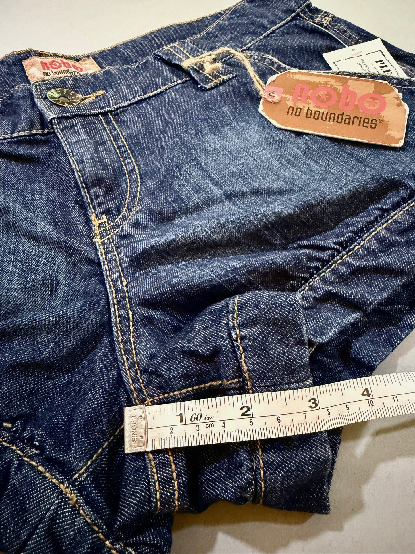 Close-up of cuffed leg opening and hem detail on 2007 Nobo jean shorts.