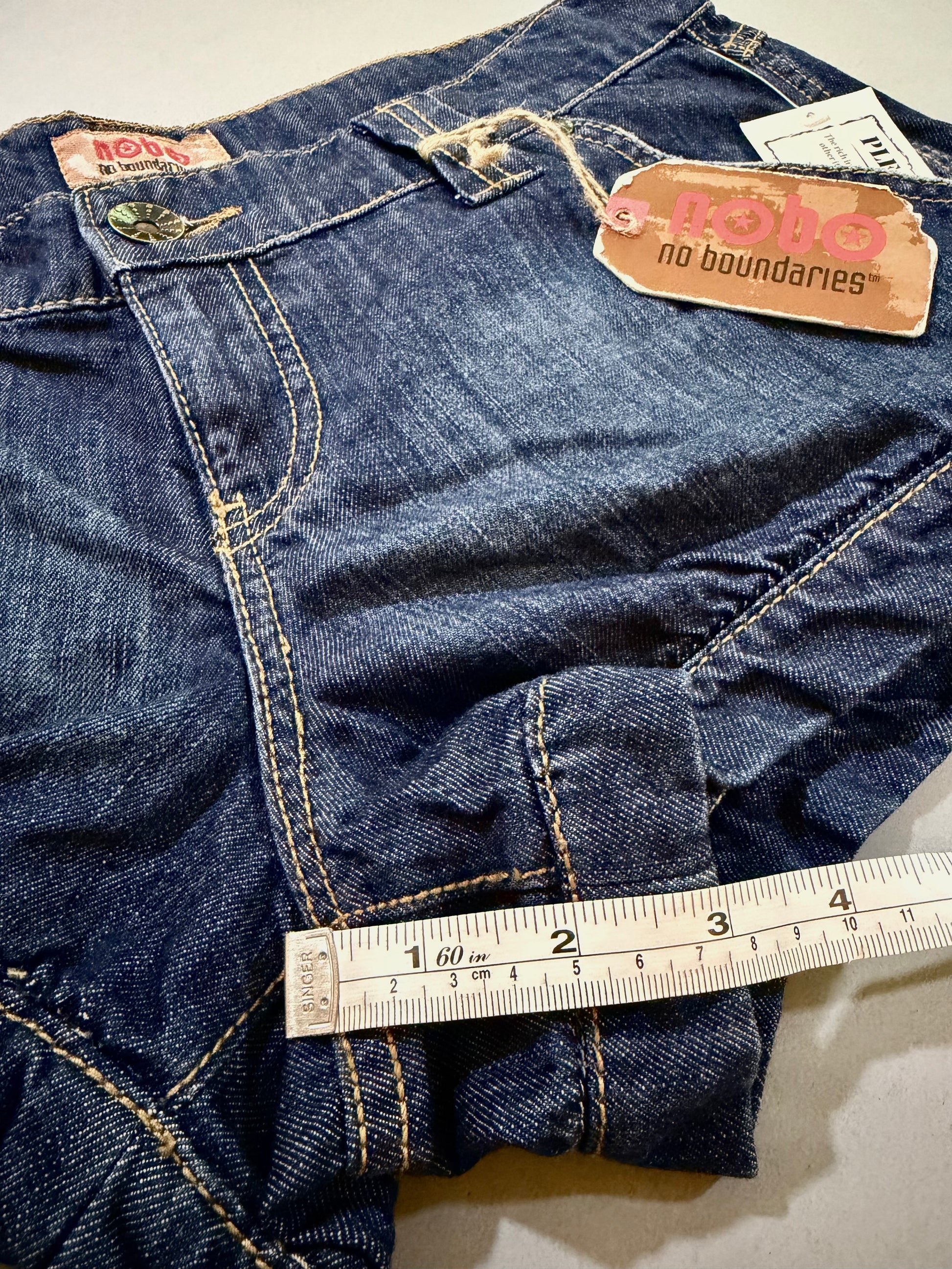 Close-up of cuffed leg opening and hem detail on 2007 Nobo jean shorts.