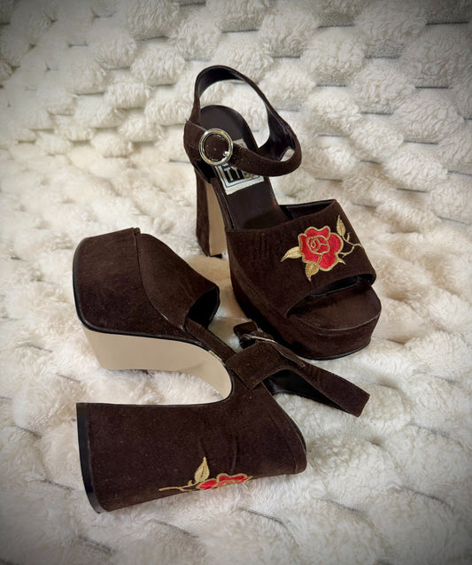 Vintage brown suede platform sandals featuring embroidered red roses, chunky heels, and ankle straps.