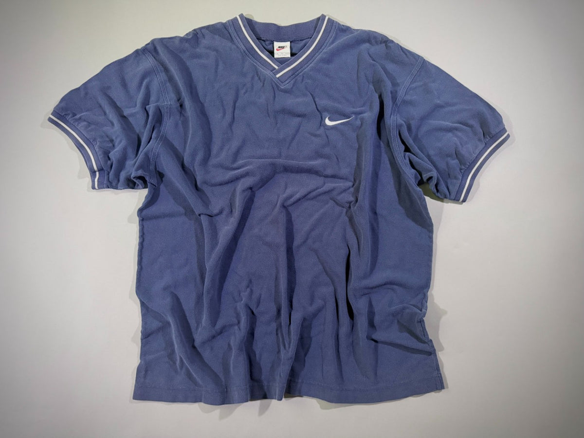 Vintage Nike navy blue V-neck T-shirt with embroidered white Swoosh logo laid flat.
