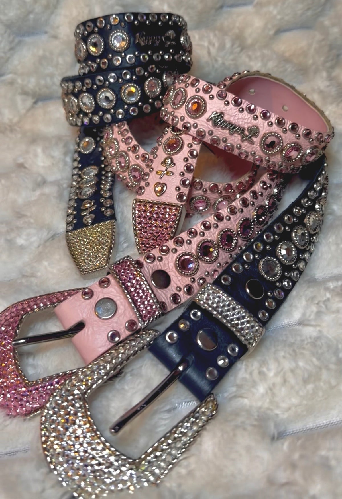 Pink and black genuine leather Swarovski studded belts, intertwined aesthetically to show details and Kippy’s metal name plate branding. 