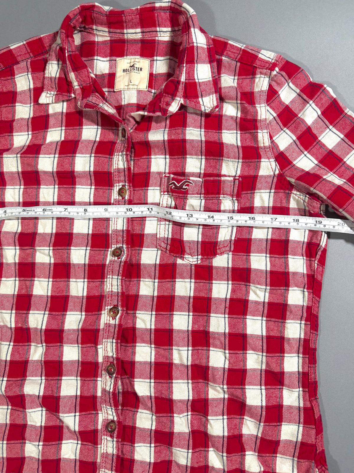 Straight shot of red flannel shirt, showing pit to pit measurement. 