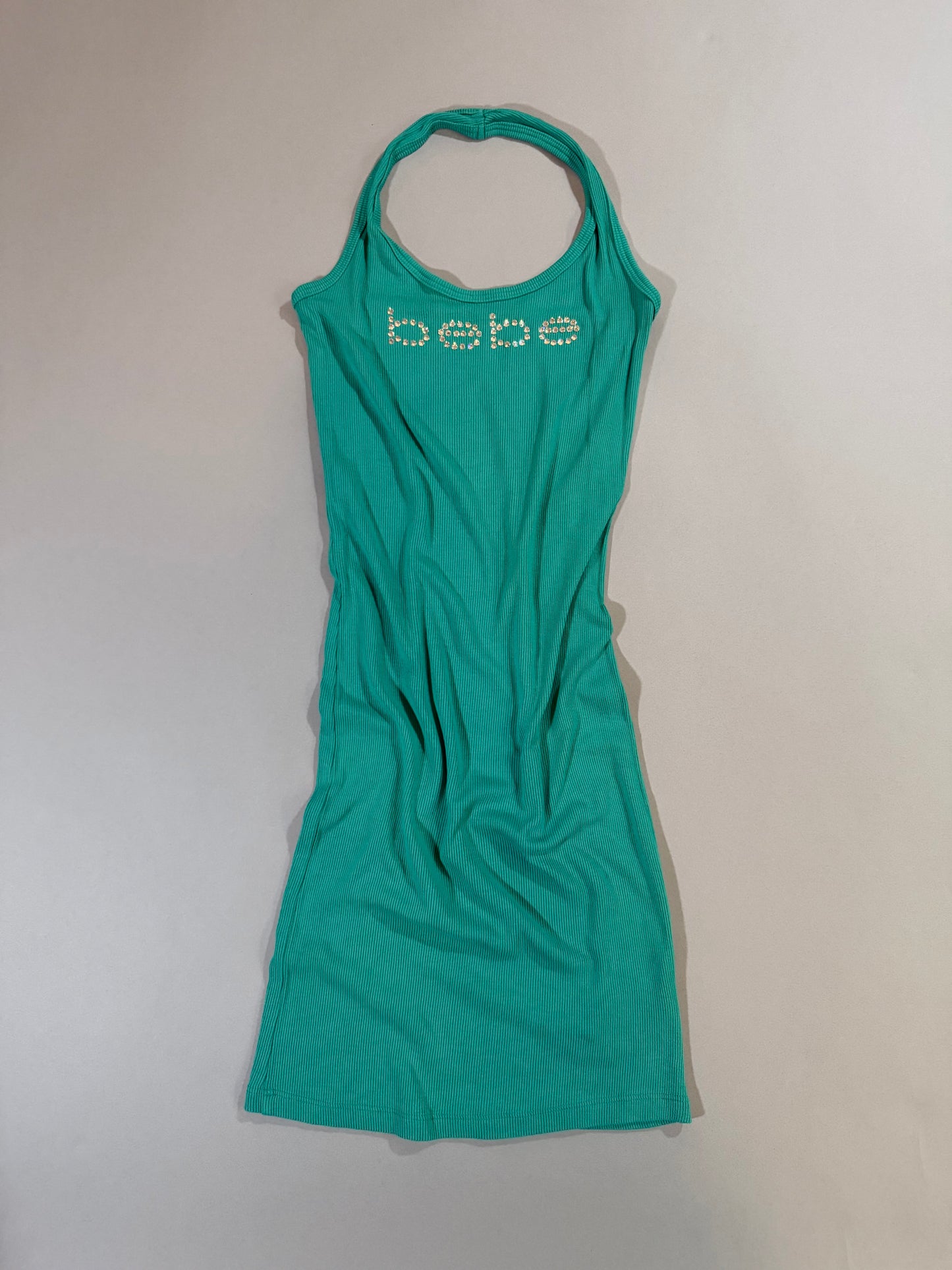 Authentic Y2K Bebe turquoise ribbed halter mini dress with rhinestone logo displayed from the front.