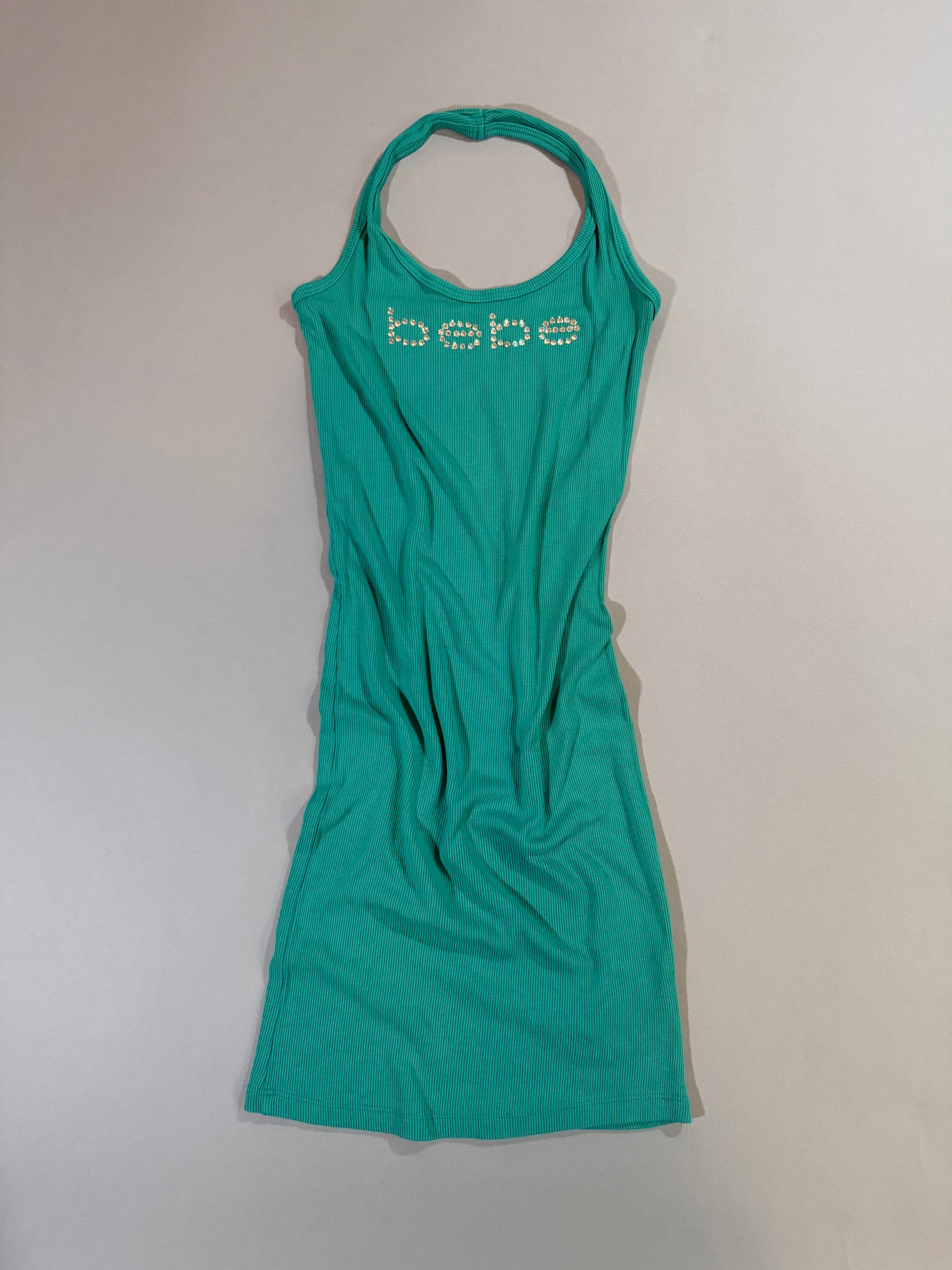 Authentic Y2K Bebe turquoise ribbed halter mini dress with rhinestone logo displayed from the front.