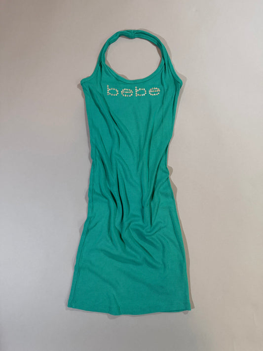 Authentic Y2K Bebe turquoise ribbed halter mini dress with rhinestone logo displayed from the front.