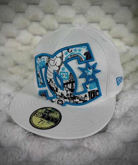 Angled view of vintage DC Shoes 59FIFTY fitted hat showing oversized graphic logo, flat brim and blue New Era side embroidery.