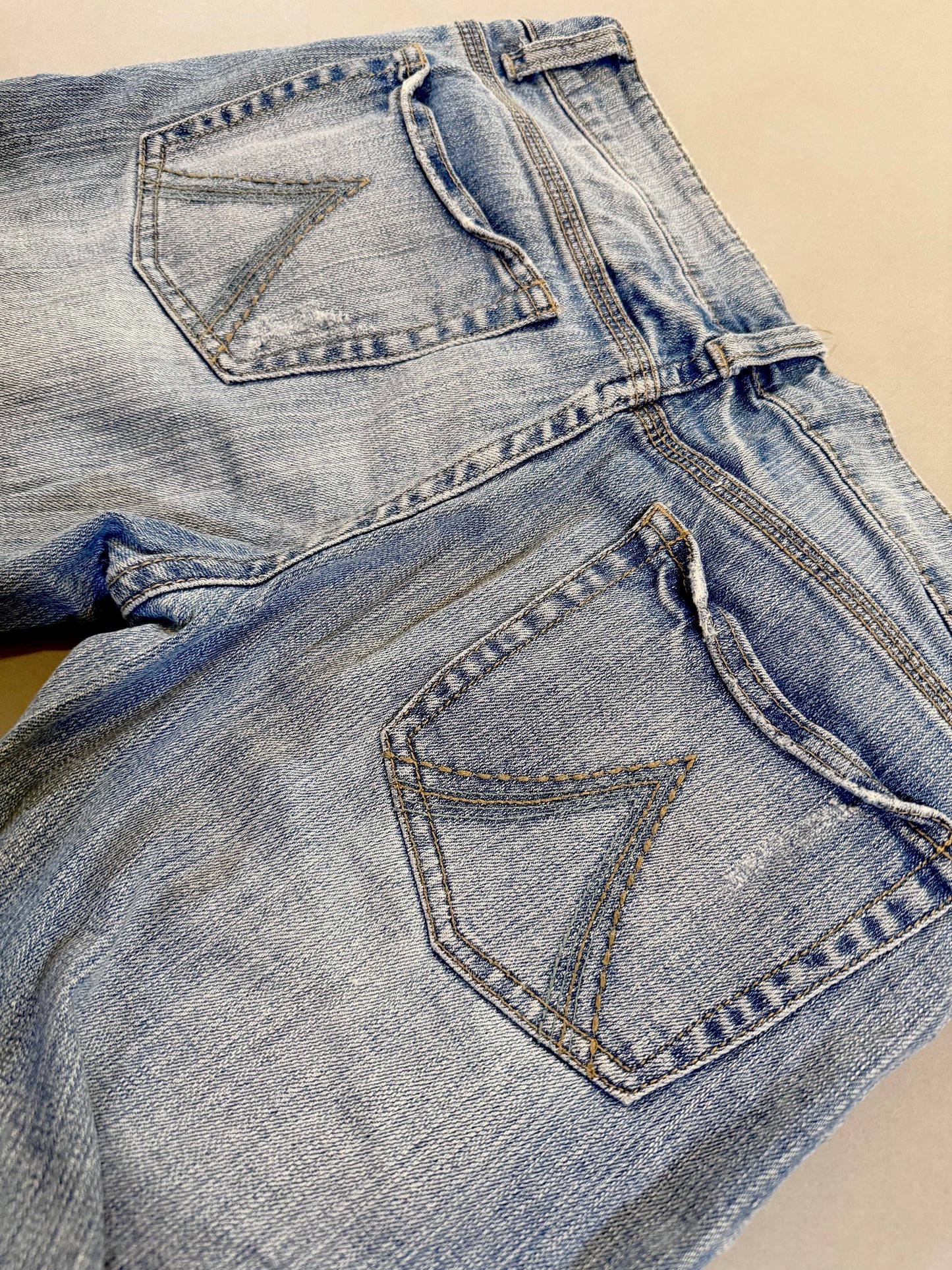 Close up of back pocket embroidery detail of y2k Delia’s bootcut jeans 