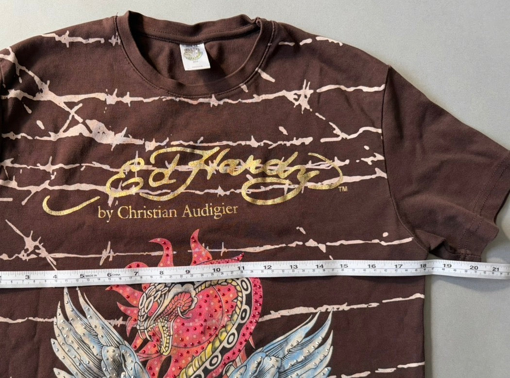 Photo of vintage Christian Audigier Ed Hardy tee with measuring tape showing 18 inches pit to pit. 