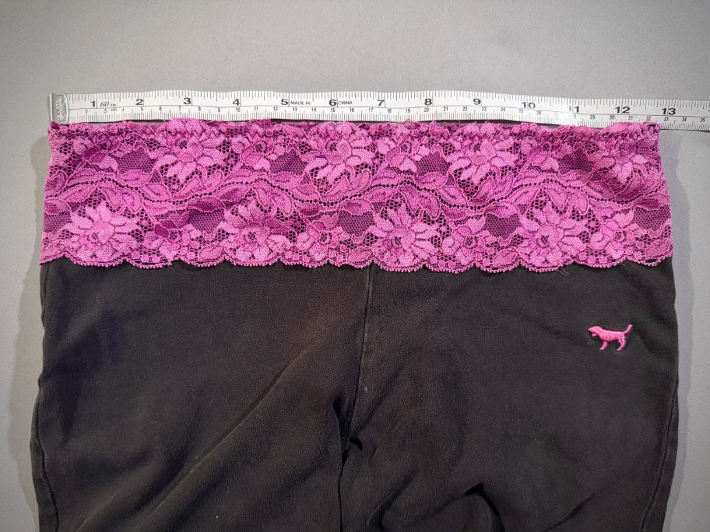 Measuring tape showing waist measurement of y2k era Victoria’s Secret flare yoga pants. 