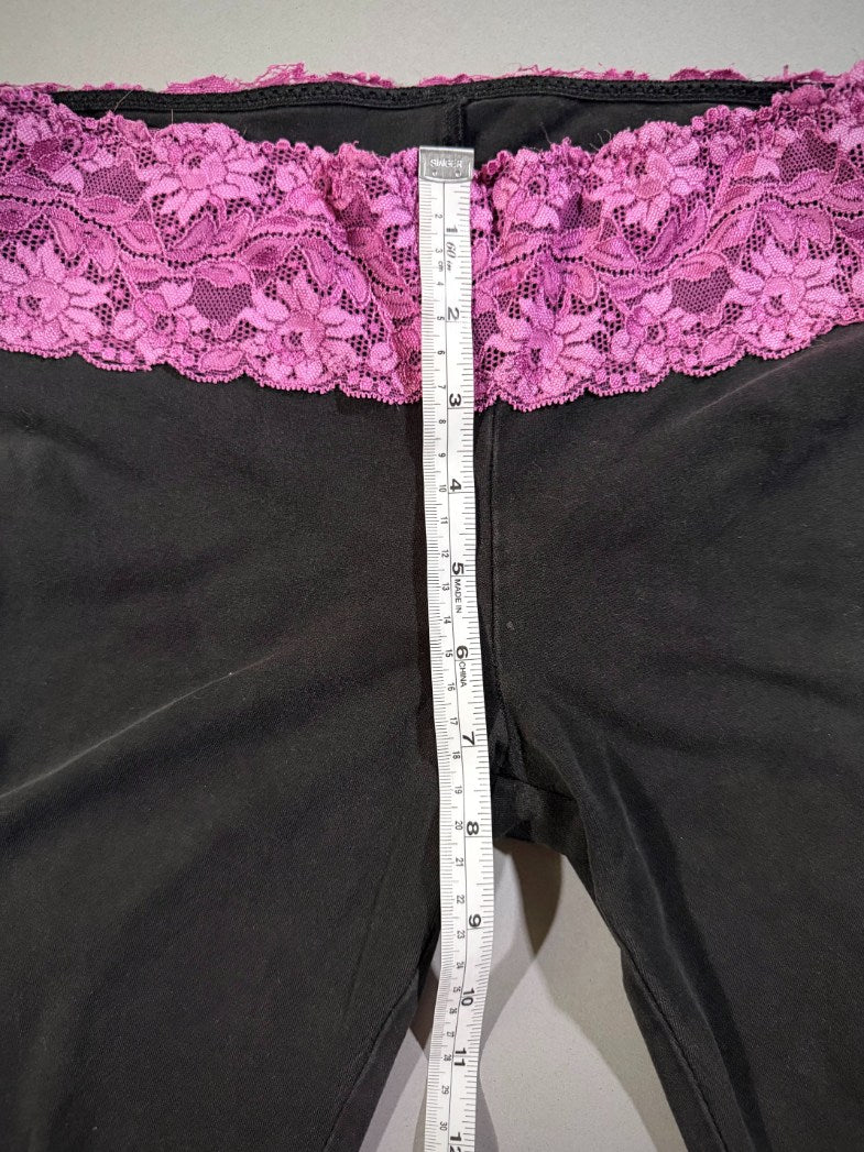 Measuring tape showing ultra low rise VS PINK yoga pants. 
