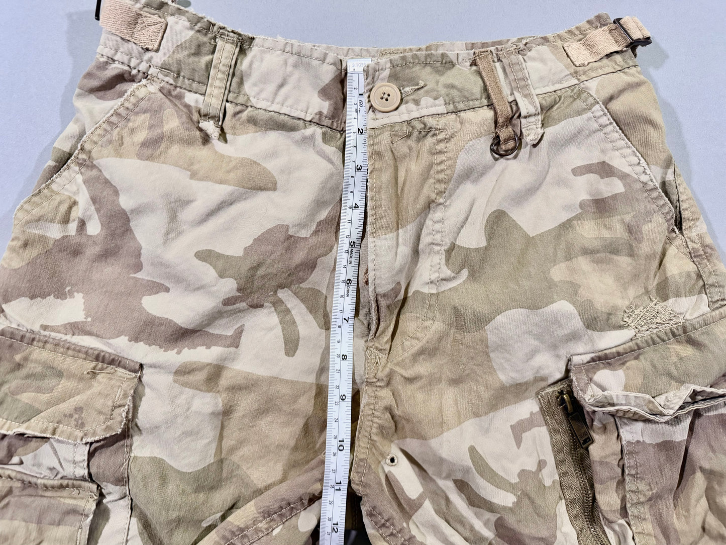 Photo of zoo York utility shorts with measuring tape showing 11 inch rise. 