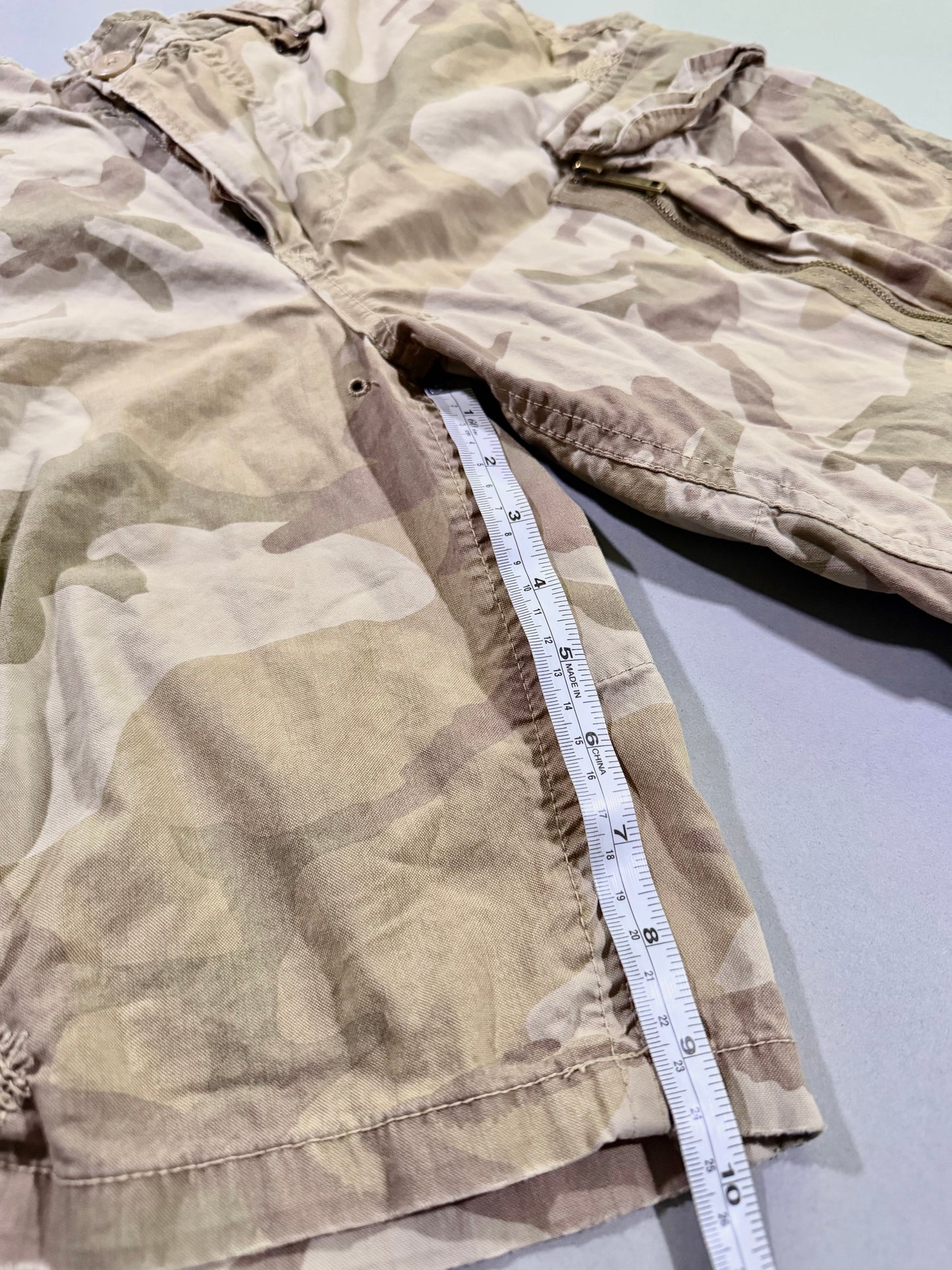 Photo of camo shorts with measuring tape showing 9.5 inch inseam