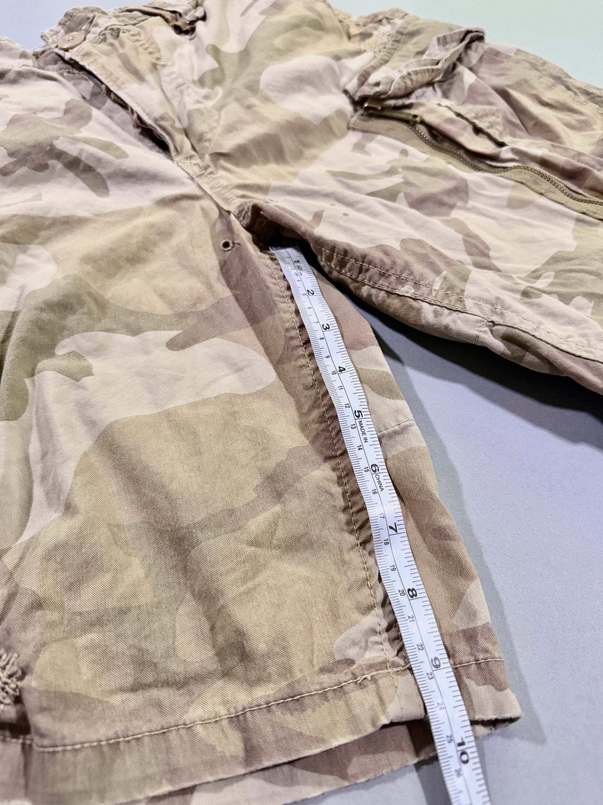 Photo of camo shorts with measuring tape showing 9.5 inch inseam